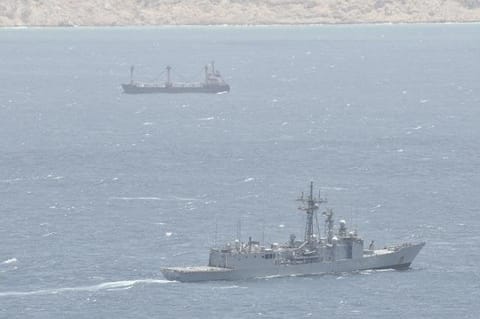 warship monitoring hijacked merchant ship