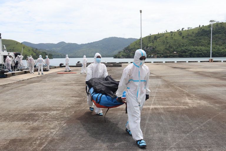 Servicemembers offload burned remains recovered from the June Aster (PCG)