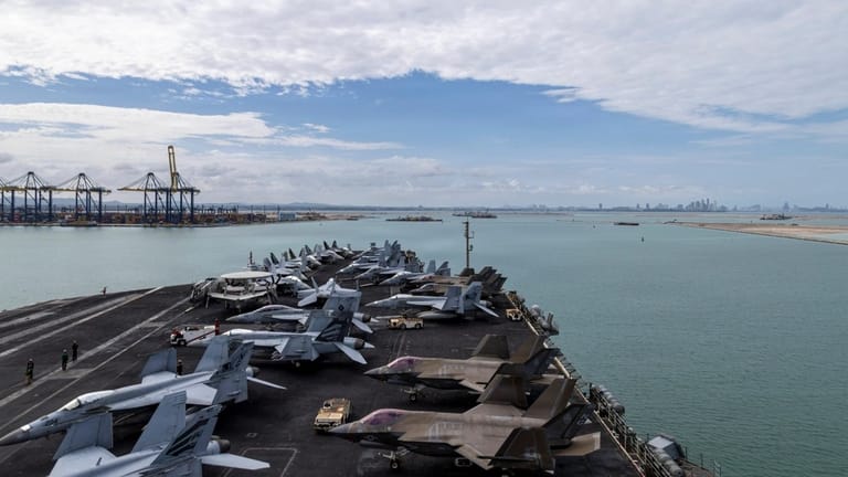 Carrier USS Abraham Lincoln arrives in Laem Chabang, Thailand after a record-setting continuous voyage at sea. Her deployment was extended twice before her return to the U.S. (USN)