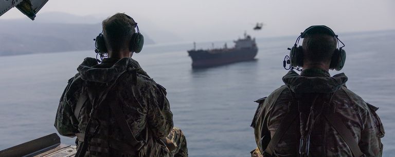 Admiral Cooper overflying an unidentified bulk carrier in the Strait of Hormuz (CENTCOM)