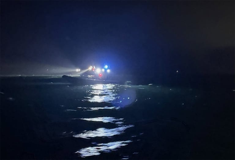 search for missing woman and child after boat was run over by cargo ship