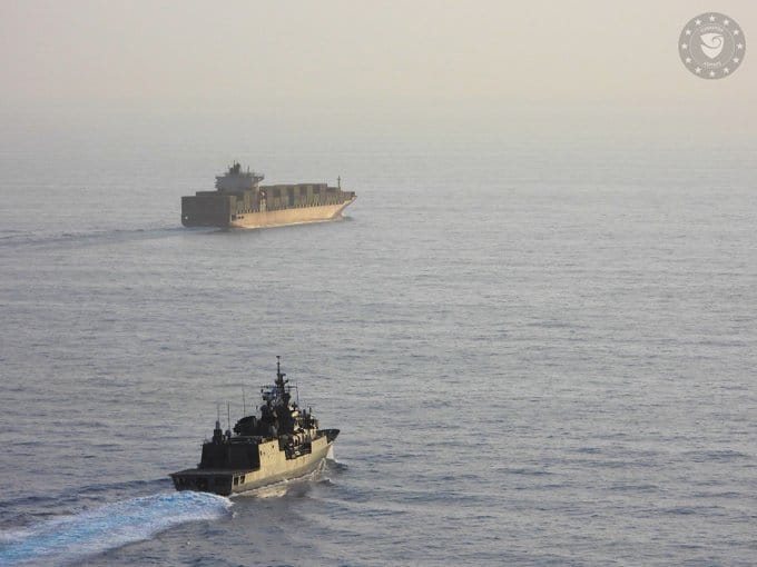 warship escorting containership in the Red Sea