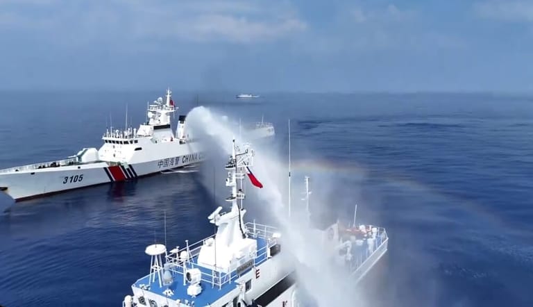 A China Coast Guard cutter water-cannons a Philippine patrol vessel (PCG file image)