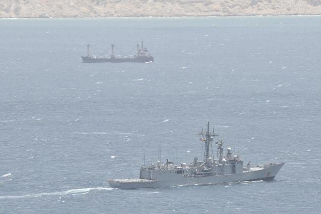 warship monitoring hijacked merchant ship