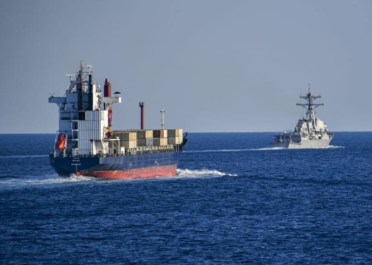 US warship monitoring cargo ship in the Strait of Hormuz