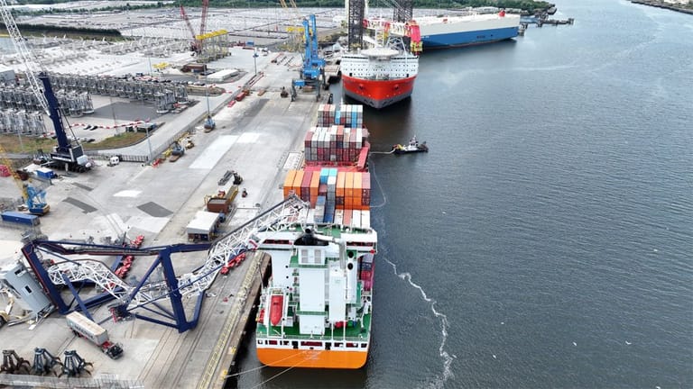 collapsed crane resting on containership
