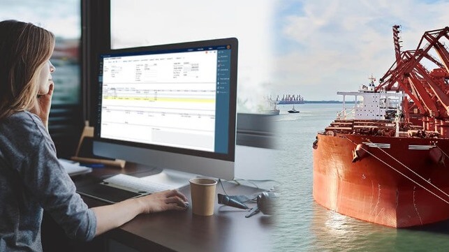 Composite image of a woman with a computer and a bulk carrier
