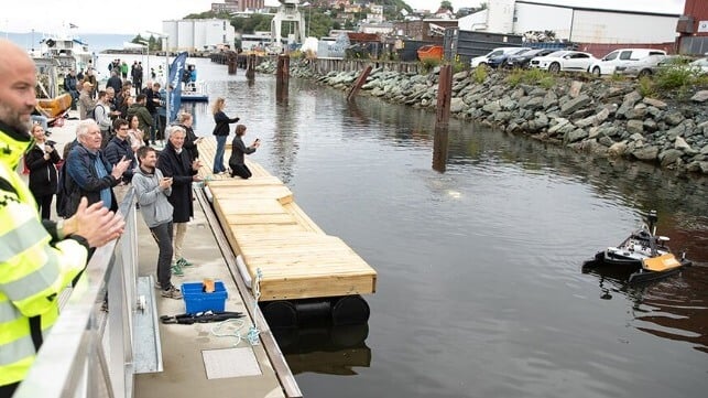 Researchers in Trondheim's harbor watch as robots navigate water