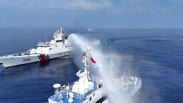 A China Coast Guard cutter water-cannons a Philippine Coast Guard patrol boat (PCG)