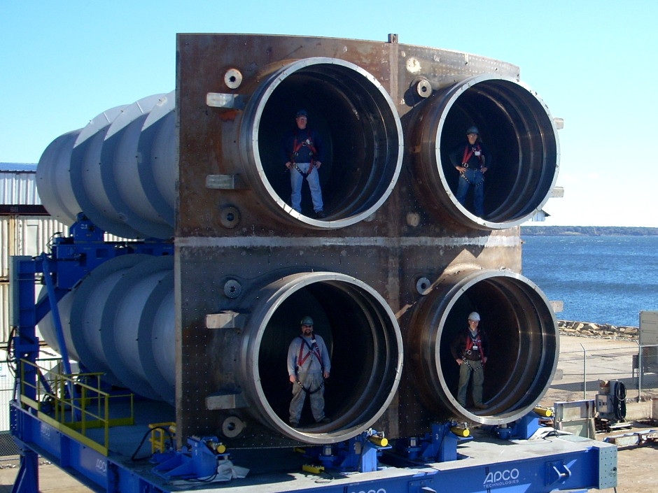 Workers pose with a quad pack of nuclear ballistic missile tubes for the Columbia-class (GDEB)