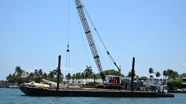 The mini-tug and the construction barge after the casualty (USCG)