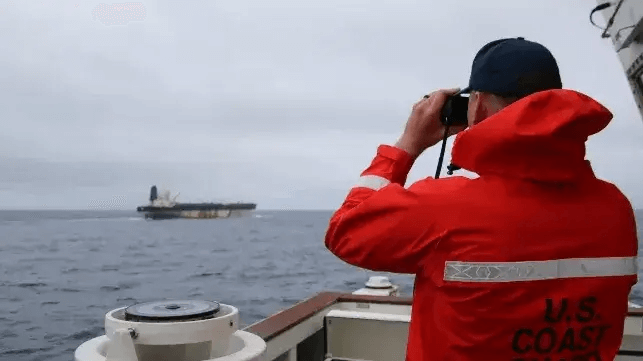 A Coast Guard officer watches as the seizure of Bella 1 unfolds, January 7 (USCG)