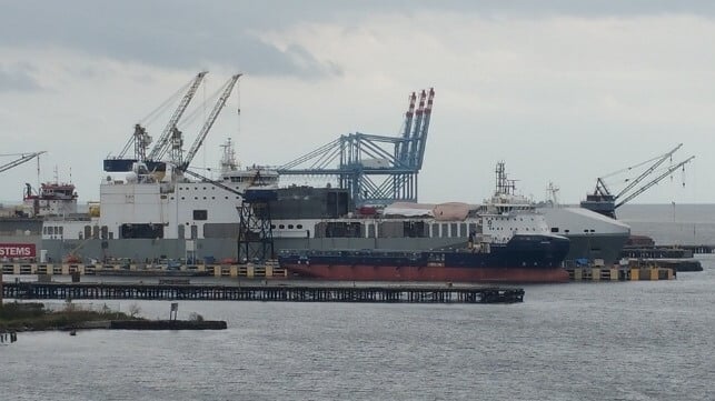 The ro/ro ferry Cragside undergoes conversion into special operations ship Ocean Trader, Mobile, Alabama, 2015 (background with tarps on deck) (Jabarnes / CC BY SA 4.0)