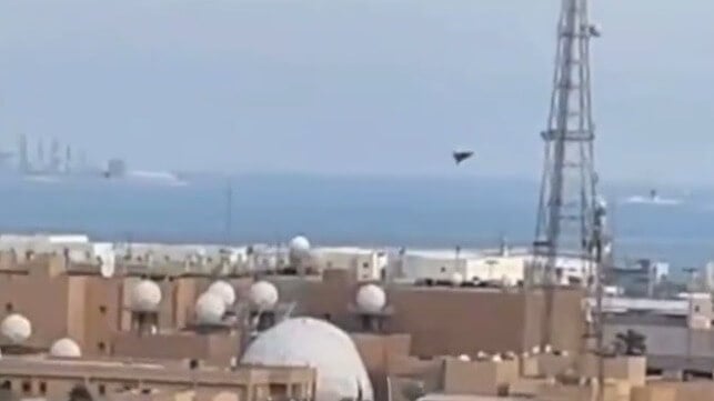 An Iranian Shahed-type drone dives on a large radome or satcom antenna at U.S. 5th Fleet's base in Manama (Bahraini social media)