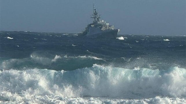 UK warship arriving in swells at Tristan da Cunha