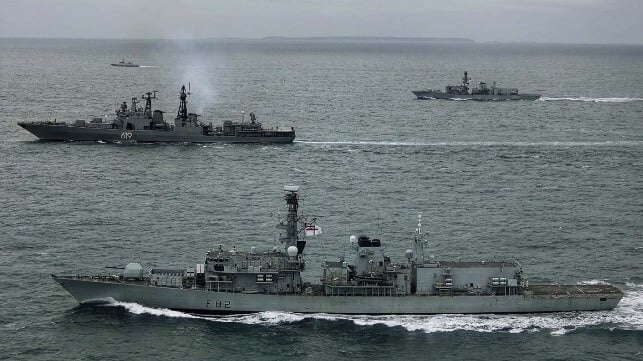 Two Type 23 frigates closely follow the Russian frigate Severomorsk (center left, smoking) (Royal Navy)