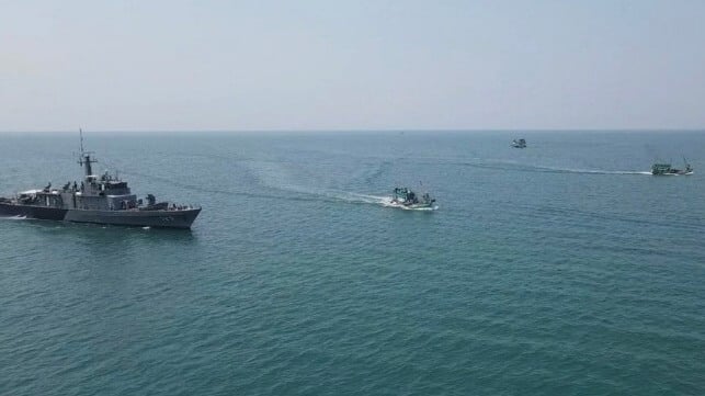Thai warship and Cambodian fishing boats