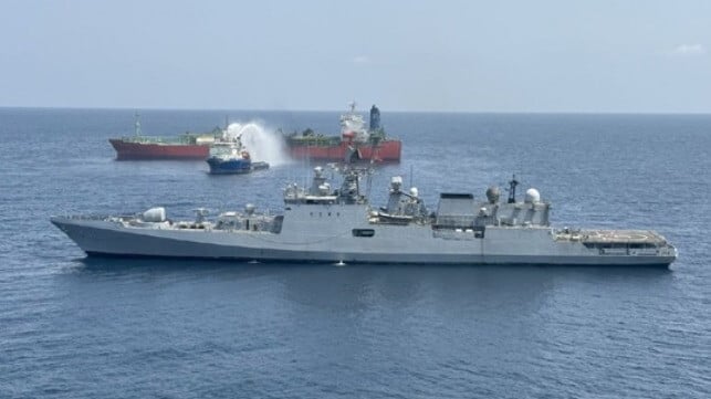 Indian warship and burning LPG carrier