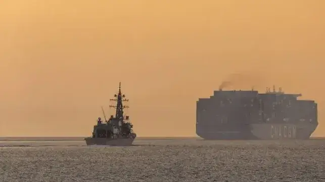 Japanese destroyer JS Yudachi and a merchant vessel navigating the Malacca Strait during regional presence deployment in February 2026 (Abdus Chowdhury/Defence Imagery)