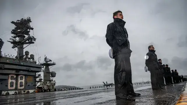 USS Nimitz returns to a cold, wet welcome in Bremerton, Washington, December 16 (USN)