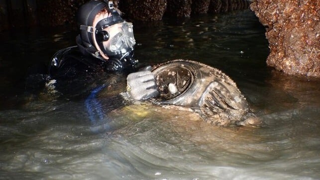 A police diver retrieves one of the two seabob mini-jetskis that the two men intended to use in their plot (AFP)