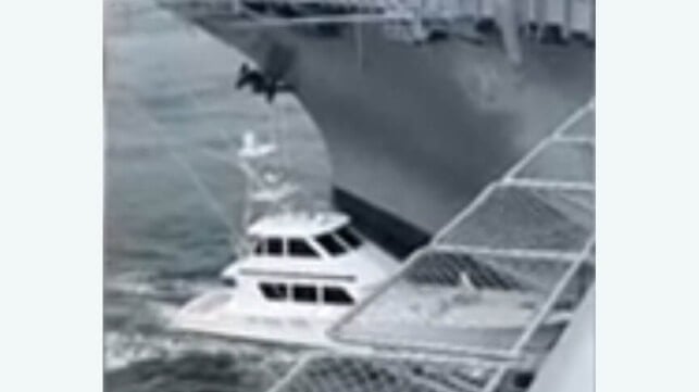 boat hitting aircraft carrier