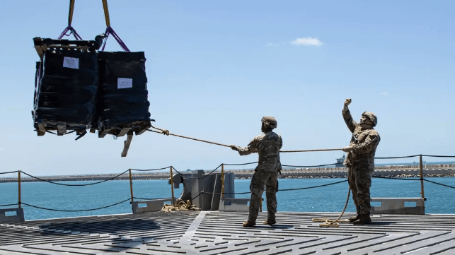U.S. Army soldiers handle an aid cargo delivery aboard the USNS Roy P. Benavidez (U.S. Army)