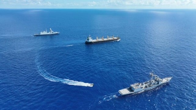 warships escorting merchant cargo ship