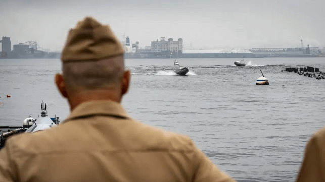 Acting CNO Adm. Jim Kilby watches BlackSea GARC boats in Baltimore, weeks before the collision (USN)
