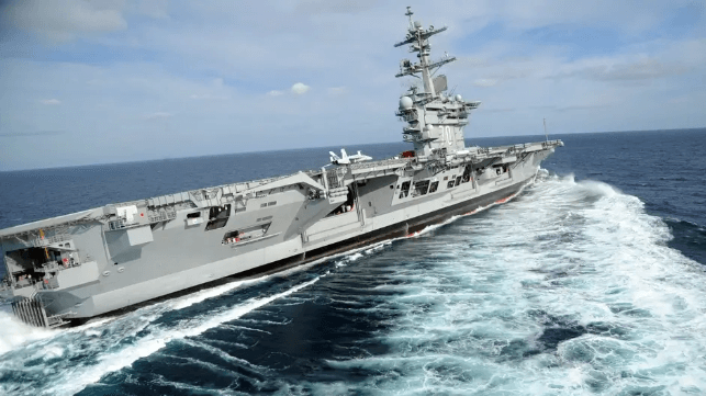 Carrier USS Carl Vinson carries out a high speed turn during sea trials (USN file image)