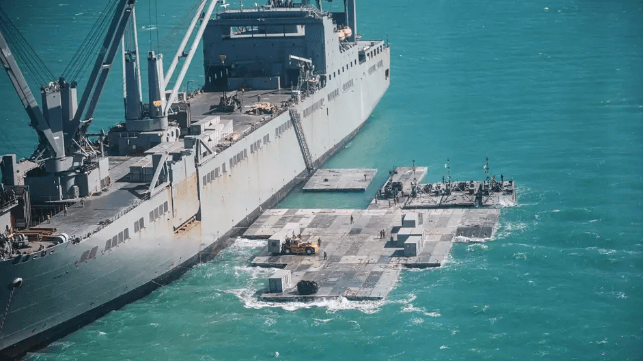 U.S. servicemembers assemble a floating pier alongside a Military Sealift Command cargo ship for a Joint Logistics Over the Shore (JLOTS) exercise (U.S. Army file image)