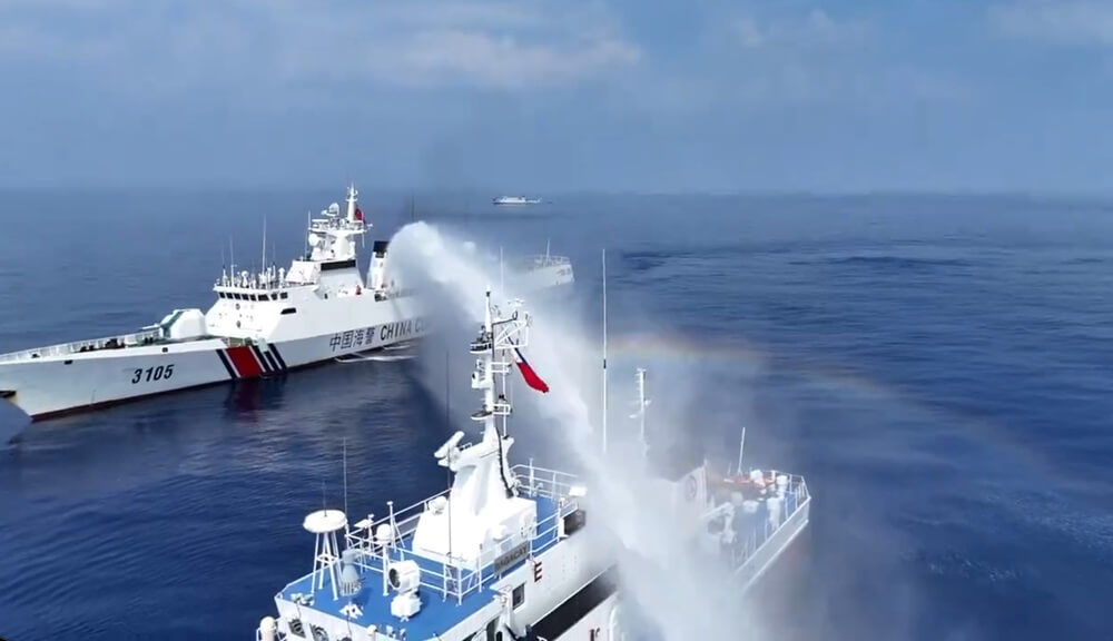 A China Coast Guard cutter water-cannons a Philippine patrol vessel (PCG file image)