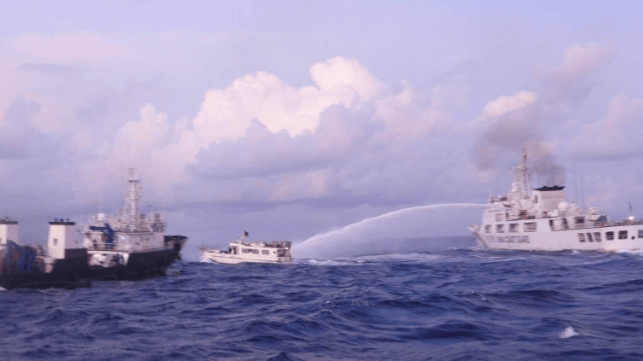 A China Coast Guard cutter harasses a Philippine supply boat with water cannon (Philippine Coast Guard file image)