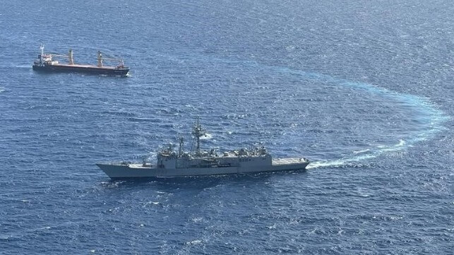 warship protecting merchant vessel