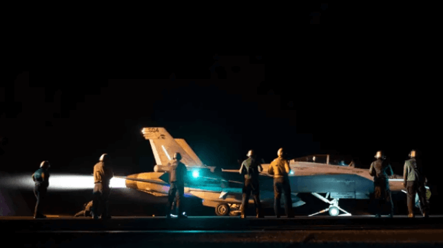 An F/A-18 fighter prepares to take off from the deck of USS Eisenhower (USN)