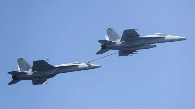 An F/A-18 equipped for a tanking role refills a second F/A-18 (USN file image)