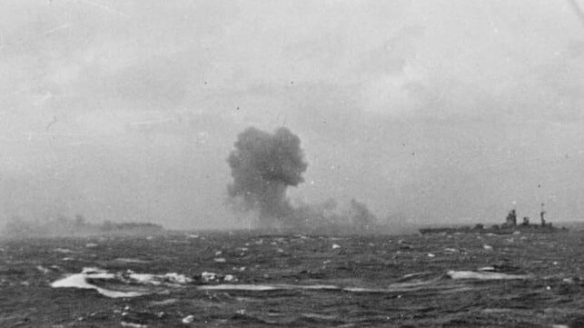 Bismarck sinking with HMS Rodney at right