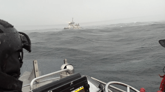 MLB crewmembers at the scene with the drifting tug Luther (USCG)