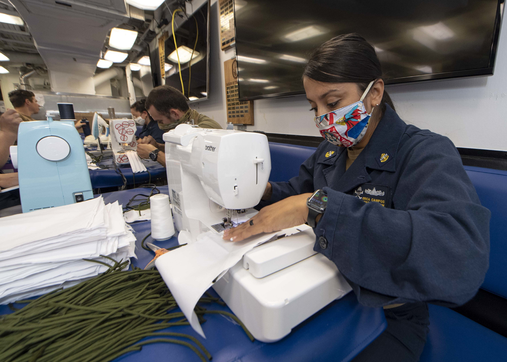 Sailors sewing masks during the COVID 19 outbreak on the USS Kidd U.S. Navy photo by Mass Communication Specialist 3rd Class Brandie Nuzzi Released