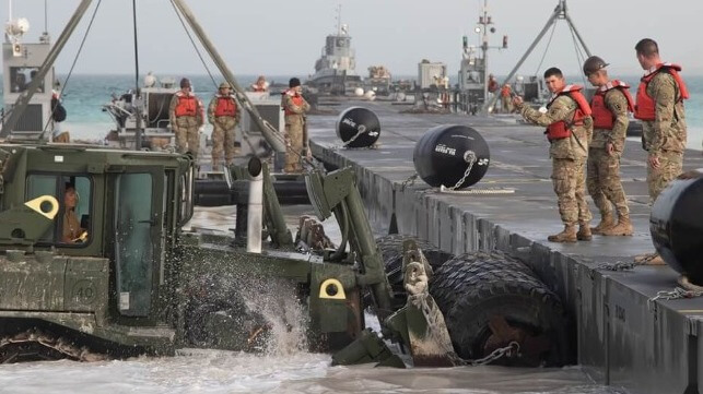 U.S. Army and Navy personnel install a temporary Trident Pier for a JLOTS exercise (U.S. Army file image)