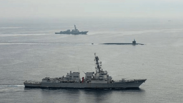 USS Kentucky arrives at Busan, flanked by destroyer escorts (USN)