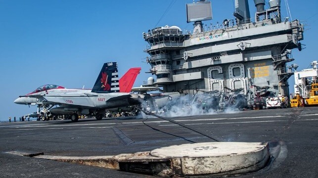Capt. Craig Sicola, commanding officer of Nimitz, and Cmdr. Luke Edwards, commanding officer of Strike Fighter Squadron VFA 22, piloted the landing in a Super Hornet on the morning of April 22