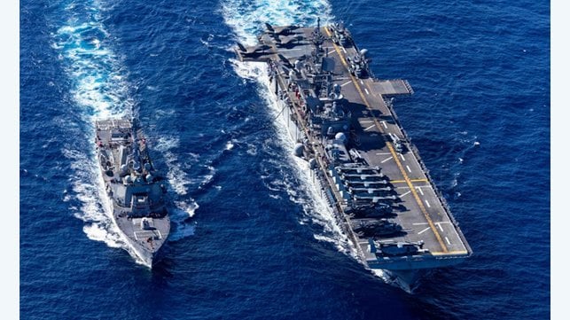 USS Tripoli and destroyer at sea