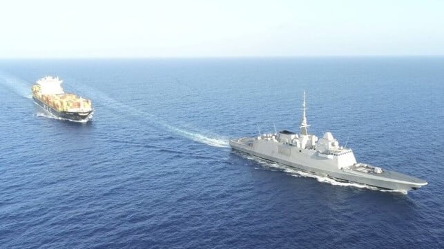 warship escorting containership