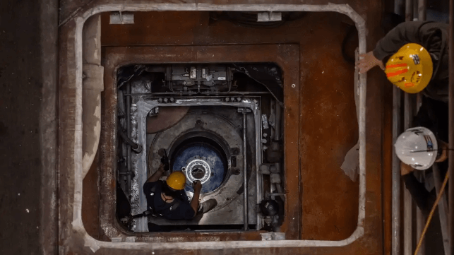 Shipyard contractors work in a rudder shaft aboard USS Ronald Reagan at PSNY (USN file image)