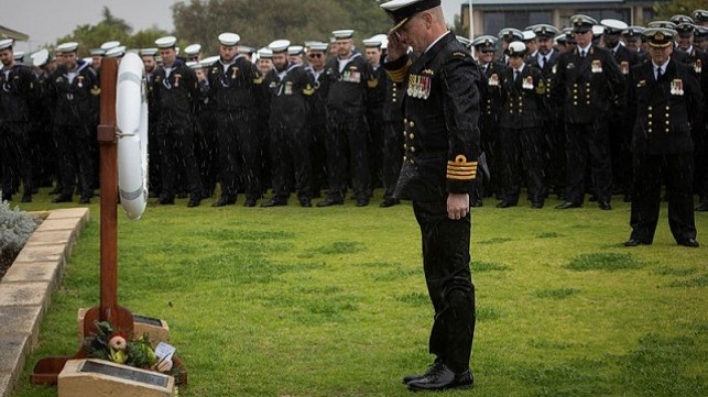 Commander Submarine Force, Captain Doug Theobald, CSC, RAN, salutes after laying a wreath at the HMAS Orion Fin Naval Memorial Park in Rockingham, Western Australia.