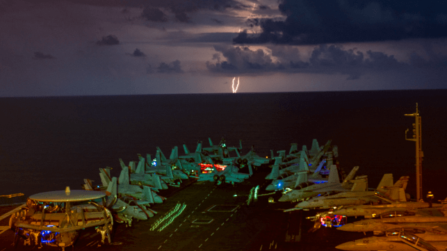 Carrier under way with lightning