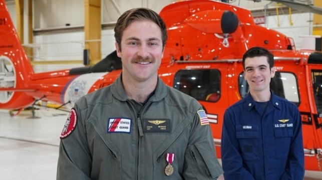 Petty Officer 2nd Class Chad Morris, an aviation survival technician at Coast Guard Sector North Bend, is presented with the Meritorious Service Medal by Petty Officer 3rd Class Alexander Neuman.