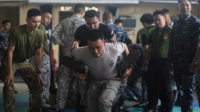 U.S., Thai and Indonesian Coast Guardsmen and Sailors practice proper wounded evacuation techniques during the visit, board, search and seizure (VBSS) workshop as part of Southeast Asia Cooperation and Training (SEACAT) 2019 at the Philippine Coast Guard Headquarters in Manila.