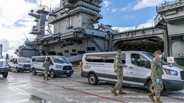 Seabees coordinate transportation of Sailors assigned to the aircraft carrier USS Theodore Roosevelt who have tested negative for COVID-19 and are asymptomatic to lodgings ashore.